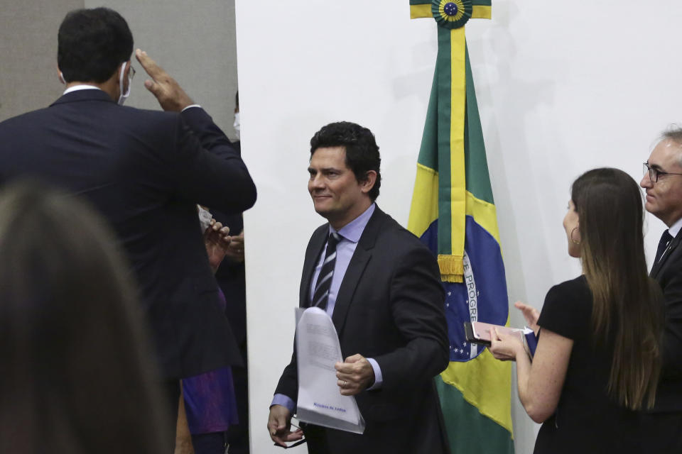 Brazil's former Justice Minister Sergio Moro is acknowledged by his staff after he announced his resignation at a press conference in Brasilia, Brazil, Friday, April 24, 2020. Moro made the announcement after President Jair Bolsonaro decided to change the head of the country's federal police. (AP Photo/Eraldo Peres)