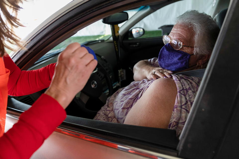 Betty Bucks, a teaching assistant who is classed in the 1B category, which includes teachers and childcare providers, receives the Pfizer-BioNtech COVID-19 vaccine at the University of Arizona in Tucson, Arizona, U.S., January 21, 2021.  REUTERS/Cheney Orr