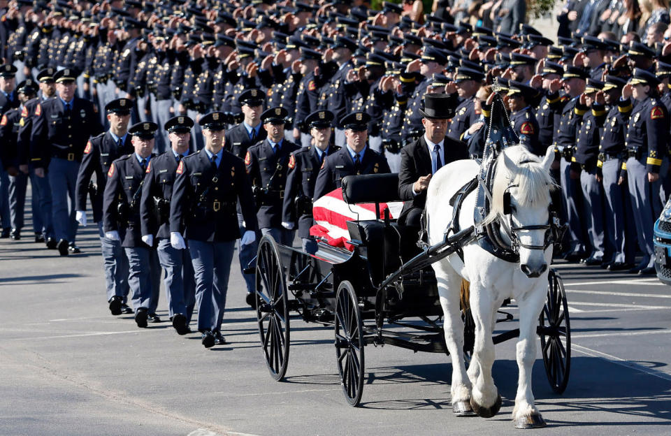 A funeral caisson transports the casket of Raleigh Police Officer Gabriel Torres to Cross Assembly Church in Raleigh, N.C. for his funeral Saturday, Oct. 22, 2022. Torres, a Raleigh police officer and former U.S. Marine, was inside his personal vehicle and about to leave for work when authorities said he was shot by a 15-year-old boy wearing camouflage clothing and firing a shotgun. (Ethan Hyman/The News & Observer via AP)