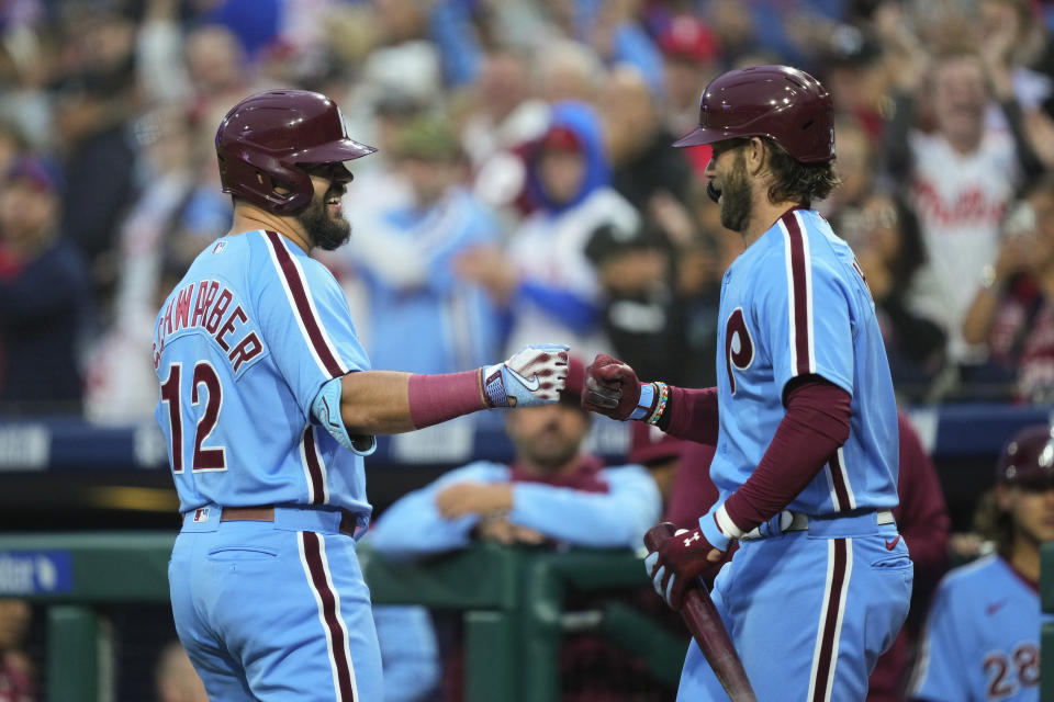 Philadelphia Phillies' Kyle Schwarber, left, celebrates his home run off of Pittsburgh Pirates' Luis Ortiz with teammate Bryce Harper during the first inning of a baseball game, Thursday, Sept. 28, 2023, in Philadelphia. (AP Photo/Matt Rourke)