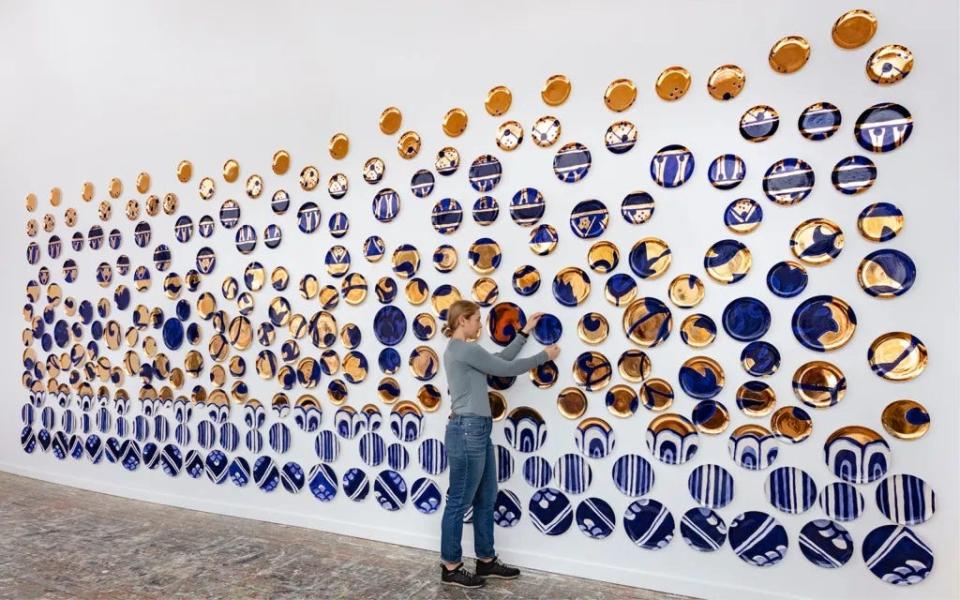 Molly Hatch, known for her installations made of hand-painted plates, is creating a new piece that will reach two floors at the Sarasota Art Museum.