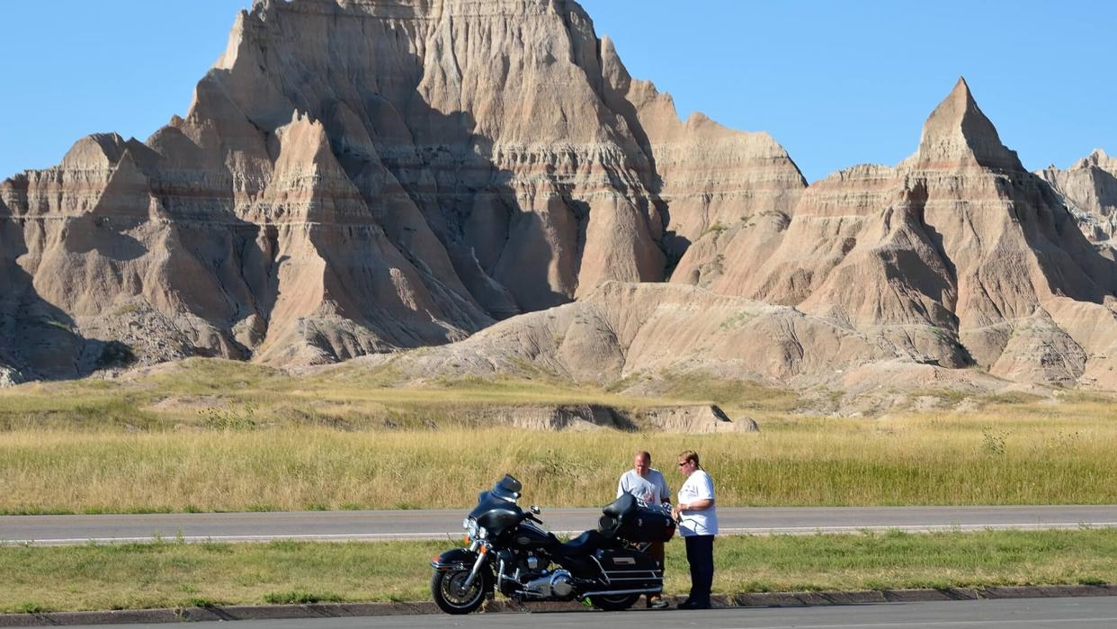 Badlands National Park, South Dakota, USA - September 5, 2011: Tourists taking a break against the rugged landscape of the Badlands National Park in South Dakota.