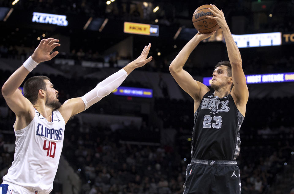 San Antonio Spurs forward Zach Collins (23) shoots over Los Angeles Clippers center Ivica Zubac (40) during the first half of an NBA basketball game Friday, Nov. 4, 2022, in San Antonio. (AP Photo/Nick Wagner)