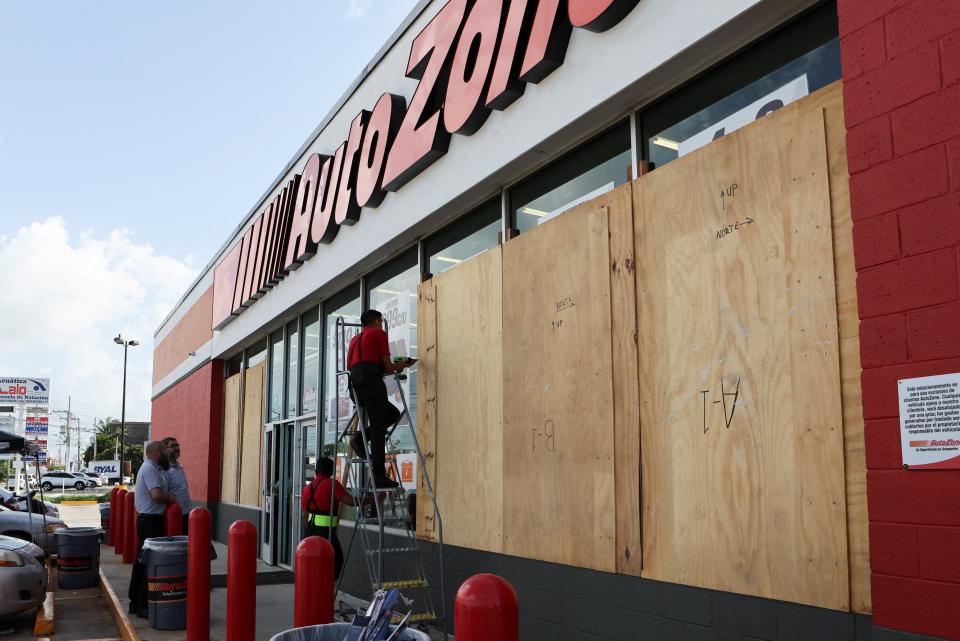 Workers board up a business to avoid damage ahead of Hurricane Beryl, in Merida, Mexico on July 3 (REUTERS)