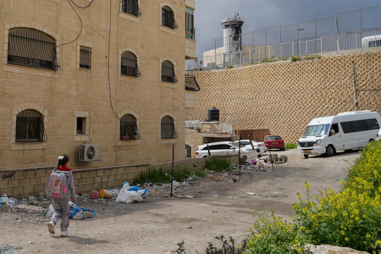 Children walk along the road where Rami Hamdan was shot and killed by Israeli police after he lit a firework. Shu'Fat Refugee Camp is located right next to Jerusalem and is home to over 16,000 Palestinians according to the United Nations Relief and Works agency for Palestine refugees in the near East.