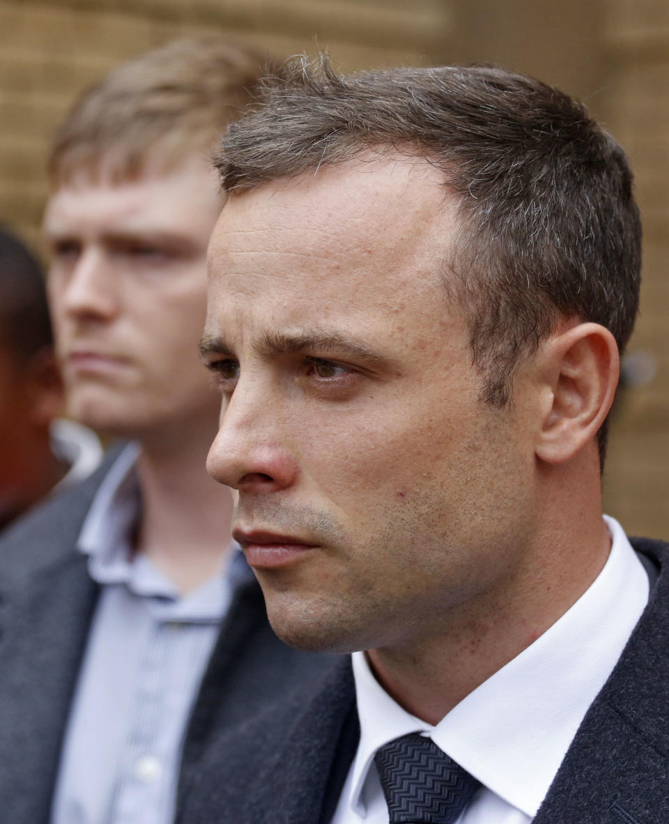 Oscar Pistorius, leaves the high court after the fifth day of his trial in Pretoria, South Africa, Friday, March 7, 2014. Pistorius is charged with murder in the shooting death of girlfriend Reeva Steenkamp in the pre-dawn hours of Valentine's Day 2013. (AP Photo/Schalk van Zuydam)