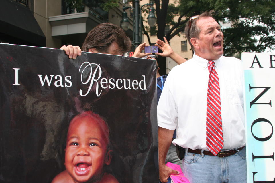 An anti-abortion activist draws a crowd as he expresses his views in downtown Charlotte, N.C. on Tuesday Sept. 4, 2012. (Torrey AndersonSchoepe/Yahoo! News)