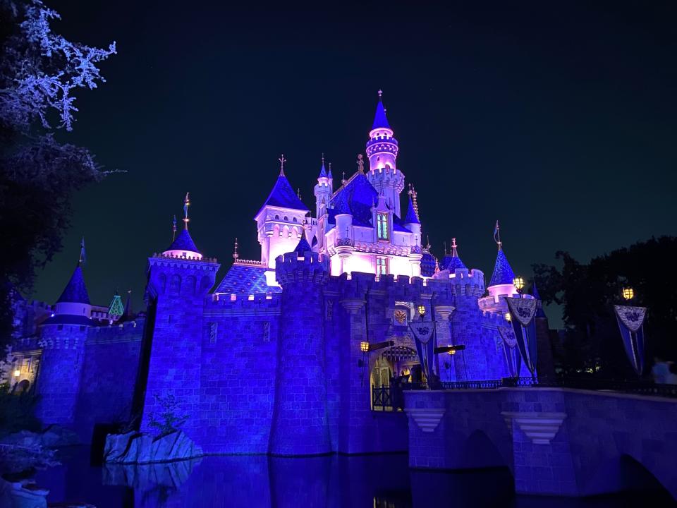 sleeping beauty castle at disneyland lit up at night