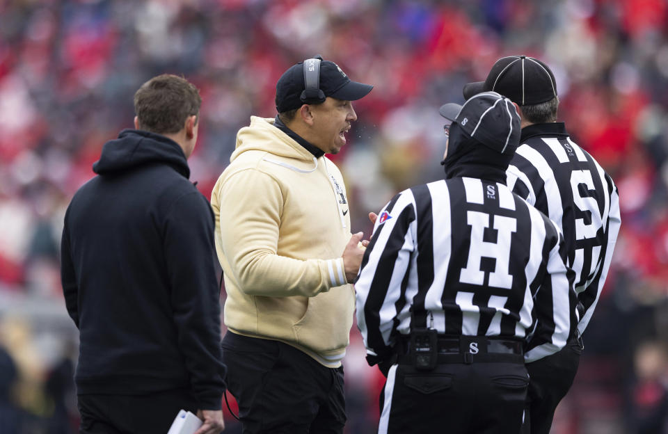 Purdue head coach Ryan Walters, center, speaks with referees after his team recovered a fumble by Nebraska's Garrett Snodgrass on a kickoff return to start an NCAA college football game Saturday, Oct. 28, 2023, in Lincoln, Neb. Referees initially ruled Nebraska recovered the fumble but overturned the call upon further review. (AP Photo/Rebecca S. Gratz)