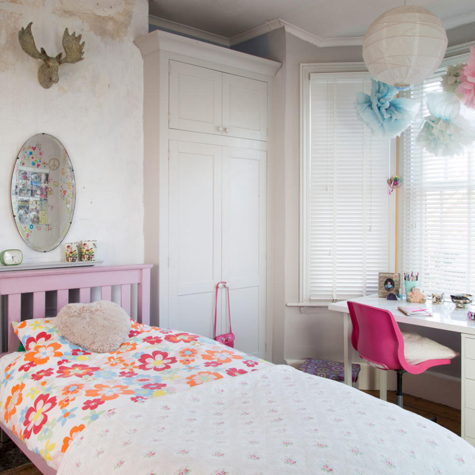 white bedroom with desk, wardrobe and painted wooden bed