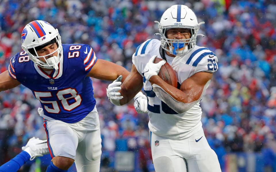 Buffalo Bills outside linebacker Matt Milano (58) trails behind as Indianapolis Colts running back Jonathan Taylor (28) runs in a touchdown during the third quarter of the game on Sunday, Nov. 21, 2021, at Highmark Stadium in Orchard Park, N.Y. 