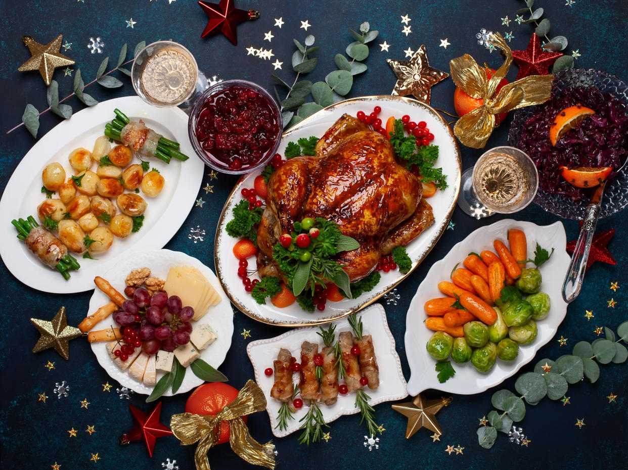 Concept of Christmas or New Year dinner with roasted chicken and various vegetables dishes. Top view.