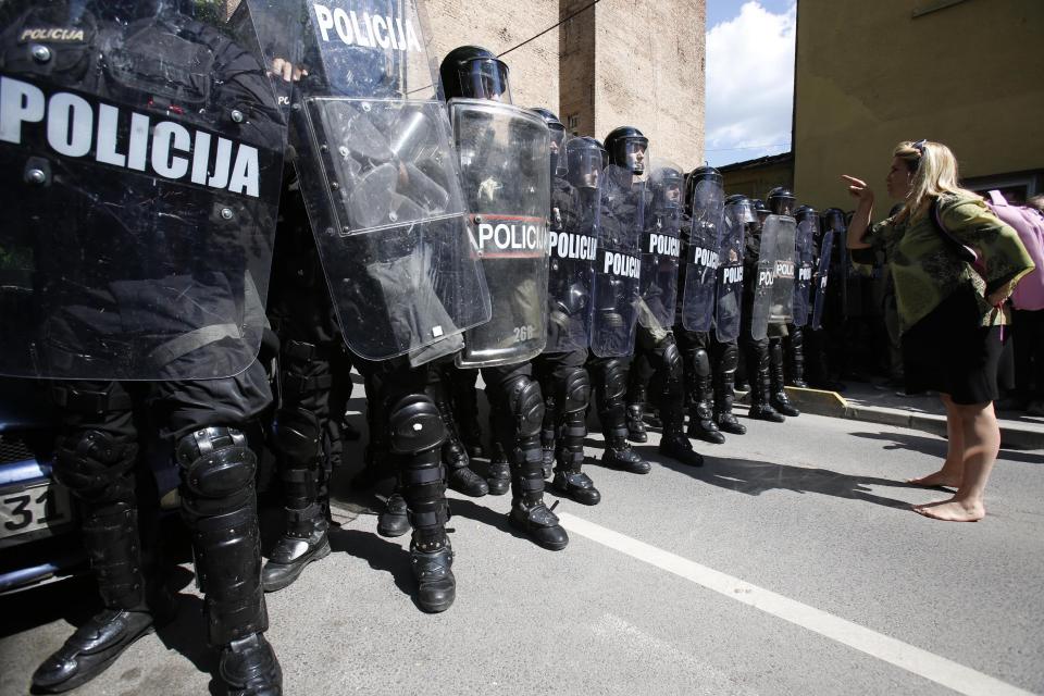 A Bosnian woman protests in front of a police cordon during a protest in the Bosnian capital of Sarajevo on Friday, May 9, 2014. A few hundred people from different parts of Bosnia have been protesting in Sarajevo over the high unemployment rate in the country and alleged government corruption. Protesters walked to the Sarajevo Library - a landmark destroyed during the Bosnian war - which is to be officially reopened today after reconstruction that has taken 18 years at the cost of over 16 million euros. They said they will continue the protest during the official ceremony to reopen the 19th century pseudo-Moorish construction that is expected to be attended by all top government officials as well as numerous international dignitaries.(AP Photo/Amel Emric)