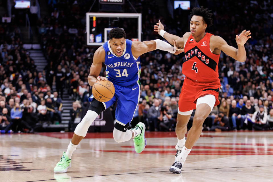 TORONTO, ON - JANUARY 04: Giannis Antetokounmpo #34 of the Milwaukee Bucks dribbles passed Scottie Barnes #4 of the Toronto Raptors during the second half of their NBA game at Scotiabank Arena on January 4, 2023 in Toronto, Canada. NOTE TO USER: User expressly acknowledges and agrees that, by downloading and or using this photograph, User is consenting to the terms and conditions of the Getty Images License Agreement. (Photo by Cole Burston/Getty Images)