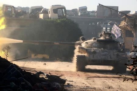 A Free Syrian Army tank fires in Ramousah area, southwest of Aleppo, Syria August 2, 2016. REUTERS/Abdalrhman Ismail/File Photo