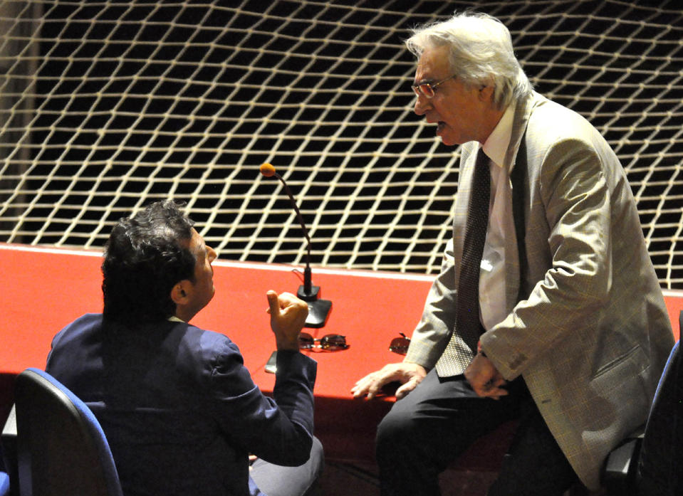 Captian Francesco Schettino, left, talks with his lawyer Domenico Pepe during a hearing of his trial, in Grosseto, Italy, Tuesday, July 9, 2013. The trial of the captain of the shipwrecked Costa Concordia cruise liner has begun in a theater converted into a courtroom in Tuscany to accommodate all the survivors and relatives of the 32 victims who want to see justice carried out in the 2012 tragedy. The sole defendant, Schettino, made no comment to reporters as he arrived for his trial on charges of multiple manslaughter, abandoning ship and causing the shipwreck near the island of Giglio. His lawyer, Domenico Pepe, told reporters that, as expected, the judge was postponing the hearing though due to an eight-day nationwide lawyers' strike. Schettino has denied wrongdoing. (AP Photo/Giacomo Aprili)