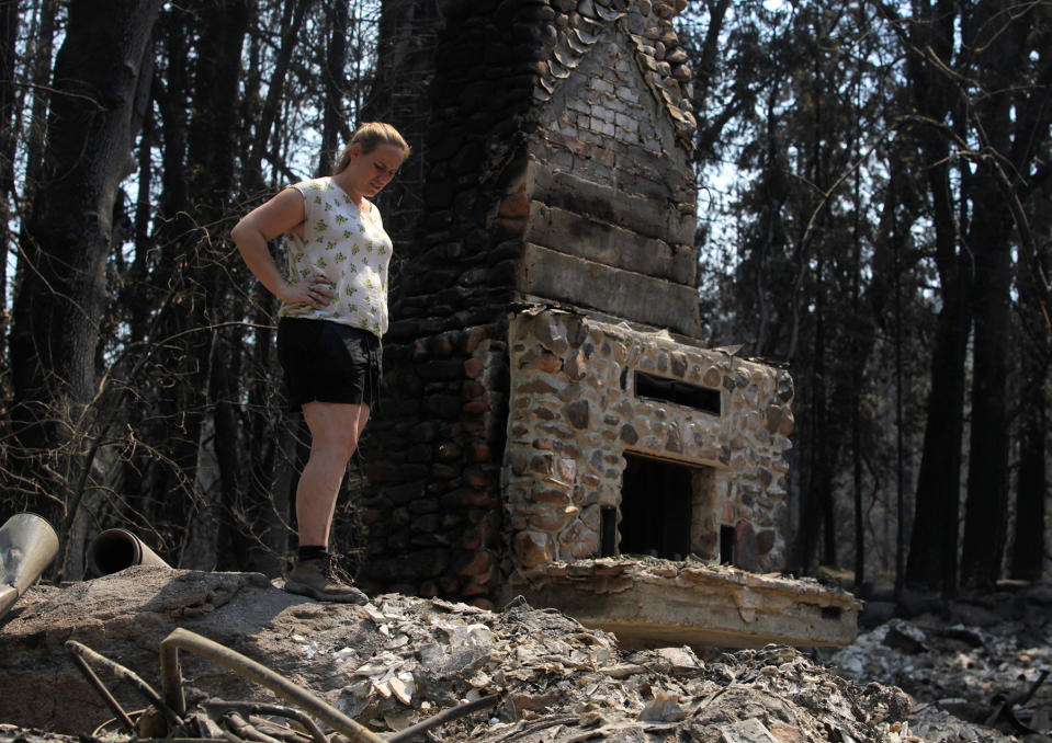 Corinna Loh gets her first look at the remains of a 4-bedroom home at her family's Spinning Wheel Ranch resort in Tuolumne County on Saturday, Aug. 24, 2013. The Rim Fire blazed through the property earlier in the week, destroying the home Loh grew up in, which was among several vacation rental homes on the property, as well as a 2-bedroom cabin. (Photo By Paul Chinn/The San Francisco Chronicle via Getty Images)