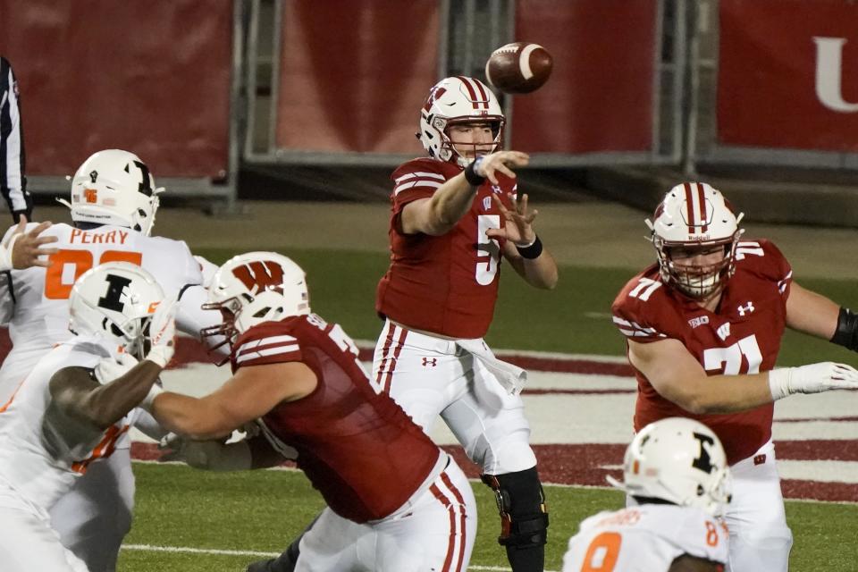 Wisconsin quarterback Graham Mertz throws a pass during the first half of an NCAA college football game against Illinois Friday, Oct. 23, 2020, in Madison, Wis. (AP Photo/Morry Gash)