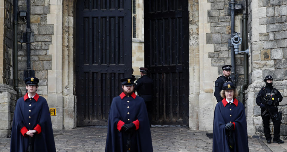 The King Henry VIII gates are tested to open and close at Windsor Castle guarded by armed police and casket wardens in Windsor, England, Tuesday, April 13, 2021. Prince Philip, husband of Britain's Queen Elizabeth II died Saturday April 10, aged 99, and his funeral will take place in Windsor upcoming Saturday. (AP Photo/Alastair Grant)