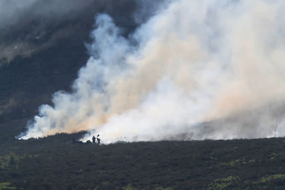 Firefighters tackling the wildfire on Saddleworth Moor.