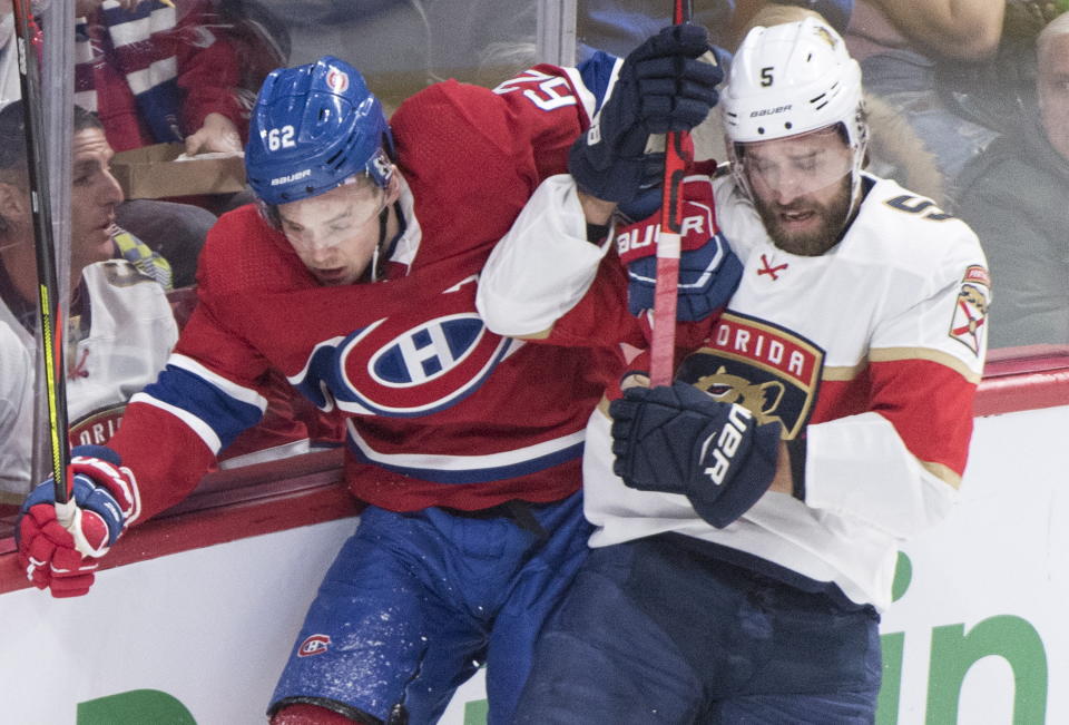 Montreal Canadiens' Artturi Lehkonen, left, checks Florida Panthers' Aaron Ekblad during the first period of an NHL hockey game, Saturday, Feb. 1, 2020 in Montreal. (Graham Hughes/The Canadian Press via AP)