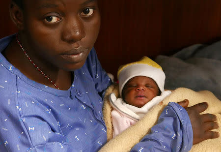 Mariam Ohene, a Nigerian migrant holds her baby girl aboard the former fishing trawler Golfo Azzurro, about thirty-two hours after her rescue along with other migrants from their drifting plastic rafts by Spanish NGO Proactiva Open Arms, in the Mediterranean Sea, off the Libyan coast April 2, 2017. REUTERS/Yannis Behrakis