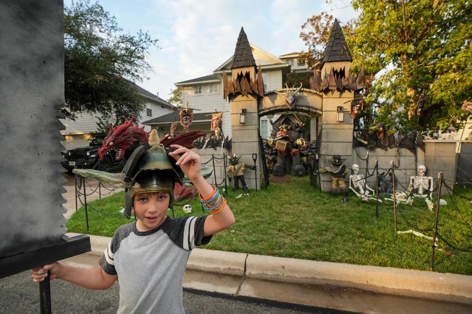 Henry Hasert, 10, dresses as an orc outside his home Oct. 24 in southwest Austin. Henry's love for Halloween has been nurtured by his dad, Bud. The two work together on the family's elaborate yard decorations.