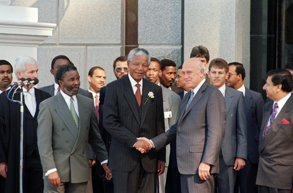 South African President Nelson Mandela shakes hands with F.W. de Klerk, the former president and one of Mandela's deputy presidents, after the inaugural sitting in May 1994<span class="copyright">Alexander Joe—AFP/Getty Images</span>