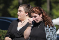 CORRECTS TO FUNERAL HOME VIEWING INSTEAD OF FUNERAL A woman wipes her tears after attending the funeral home viewing of Gabby Petito at Moloney's Funeral Home in Holbrook, N.Y. Sunday, Sept. 26, 2021. (AP Photo/Eduardo Munoz Alvarez)