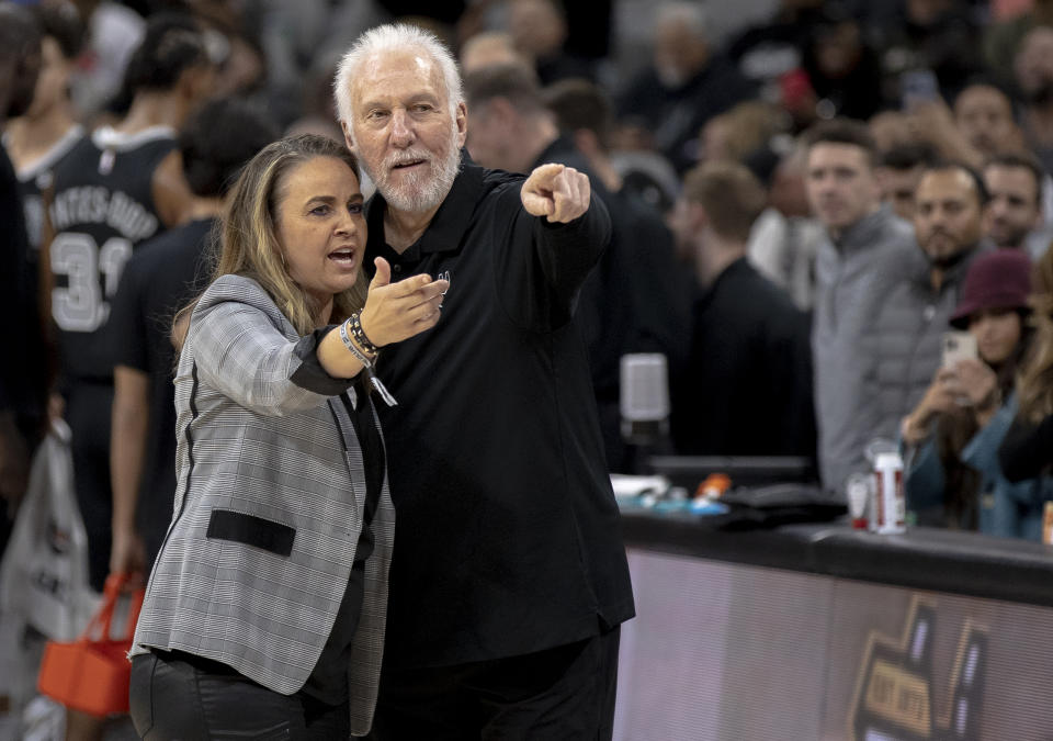 San Antonio Spurs head coach Gregg Popovich embraces former assistant coach Becky Hammon during the first half of an NBA basketball game against the Chicago Bulls, Friday, Oct. 28, 2022, in San Antonio. (AP Photo/Nick Wagner)