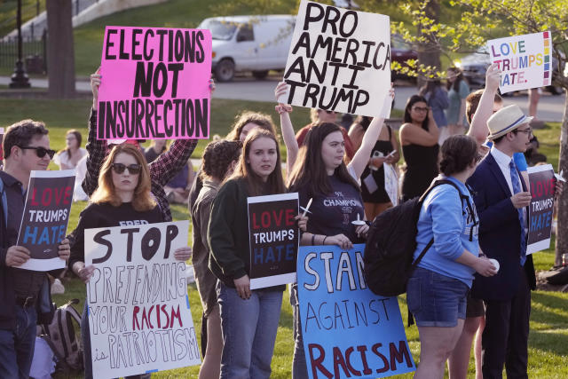 People protest outside a building on the campus of Saint Anselm College hosting a CNN televised town hall gathering with former President Donald Trump, Wednesday, May 10, 2023, in Manchester, N.H. (AP Photo/Charles Krupa)