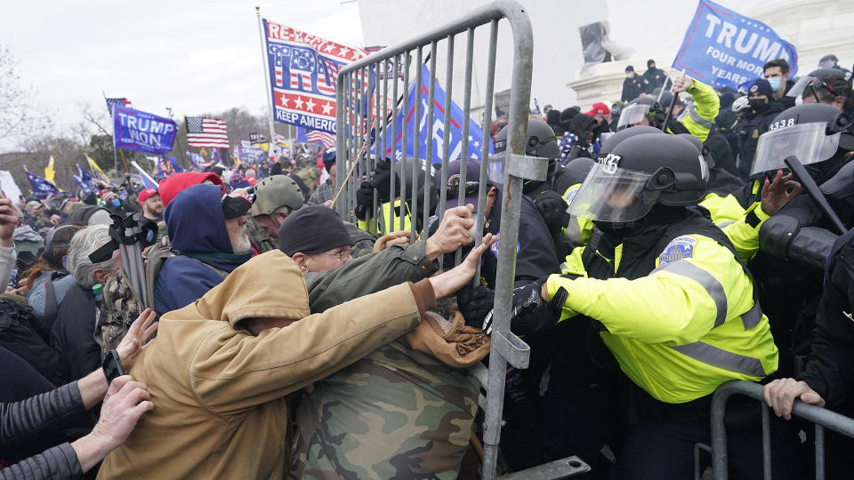 Protesters attack Capitol Police and storm the seat of government, trying to halt the Electoral College certification of ballots and throw the 2020 election to the loser, President Donald Trump, January 6, 2021 in Washington, D.C. To date, more than 700 people have been charged in the violence. Capitol Police Officer Brian Sicknick died as a result of injuries sustained that day; four other police officers committed suicide in the days and months following the attack. / Credit: Kent Nishimura/Los Angeles Times via Getty Images