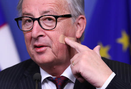 European Commission President Jean-Claude Juncker shows a bandage after his shaving injury, at the EC headquarters in Brussels, Belgium February 20, 2019. REUTERS/Yves Herman