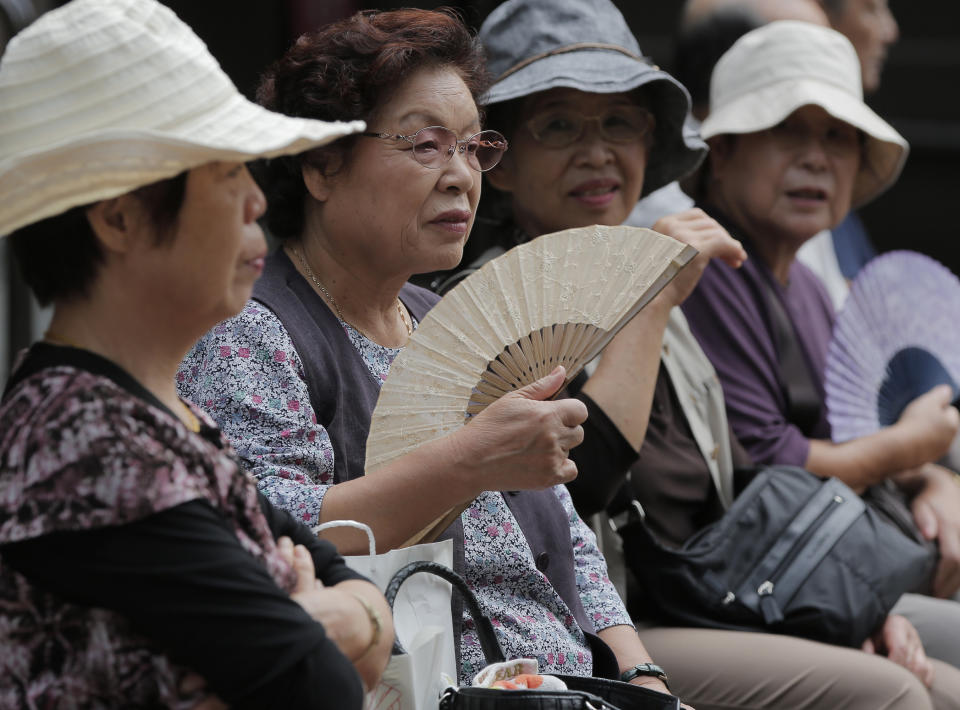 In this Saturday, Sept. 29, 2012 photo, elderly women rest at a shrine in Tokyo. The U.N. Population Fund has urged governments to build safety nets to ensure that older people have income security and access to essential health and social services as the world's elderly population grows. The U.N. agency said discrimination toward and poverty among the aged are still far too prevalent in many countries. It released its report Monday, Oct. 1, 2012 in Tokyo, capital of the world's fastest-aging country. (AP Photo/Itsuo Inouye)