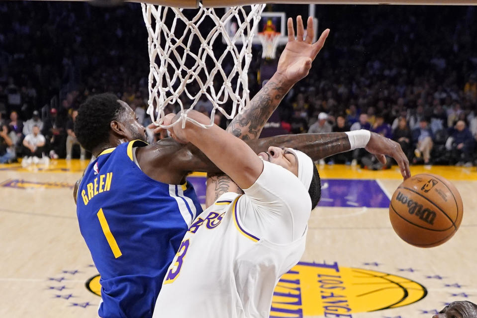 Golden State Warriors forward JaMychal Green, left, rejects a shot by Los Angeles Lakers forward Anthony Davis during the first half in Game 3 of an NBA basketball Western Conference semifinal Saturday, May 6, 2023, in Los Angeles. (AP Photo/Mark J. Terrill)
