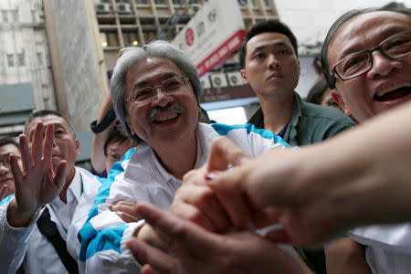 Chief Executive candidate and former Financial Secretary John Tsang greets supporters during an election campaign in Hong Kong, China March 24, 2017.REUTERS/Tyrone Siu