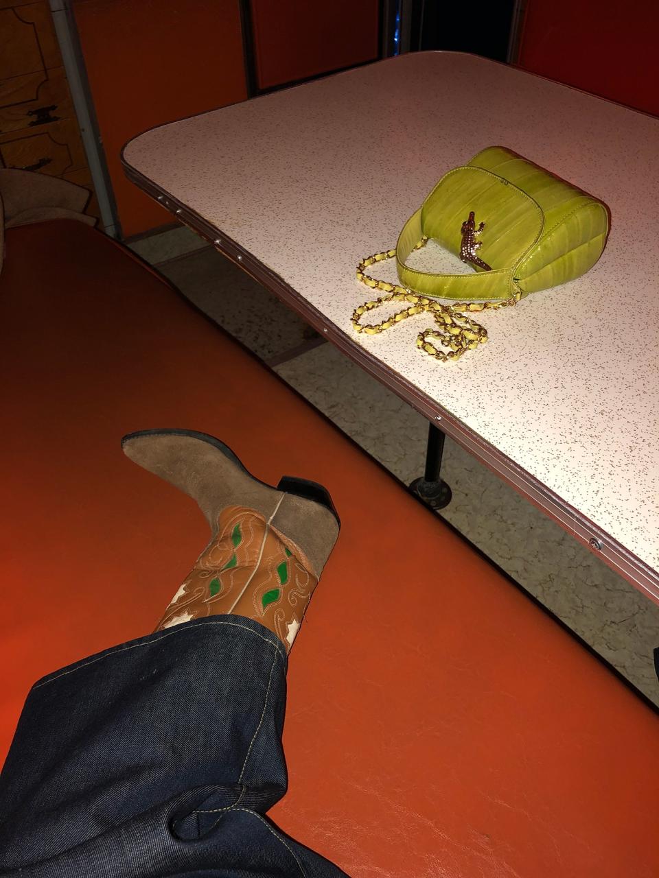 The weirdest place I’ve ever been, “The House of Eternal Return,” in Santa Fe. There are dozens of rooms, secret passages, and interactive light and musical objects. With my vintage cowboy boots, my apple green tiny bag, and my Eve Denim pant.