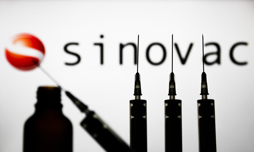 FILE PHOTO: Medical syringes are seen with Sinovac company logo displayed on a screen in the background in this illustration photo taken in Poland on November 15, 2020. (Photo: Jakub Porzycki/NurPhoto via Getty Images)