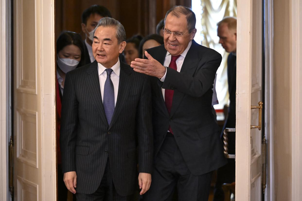 Russian Foreign Minister Sergey Lavrov, right, and the Chinese Communist Party's foreign policy chief Wang Yi enter a hall for their talks in Moscow, Russia, Wednesday, Feb. 22, 2023. (Alexander Nemenov/Pool Photo via AP)