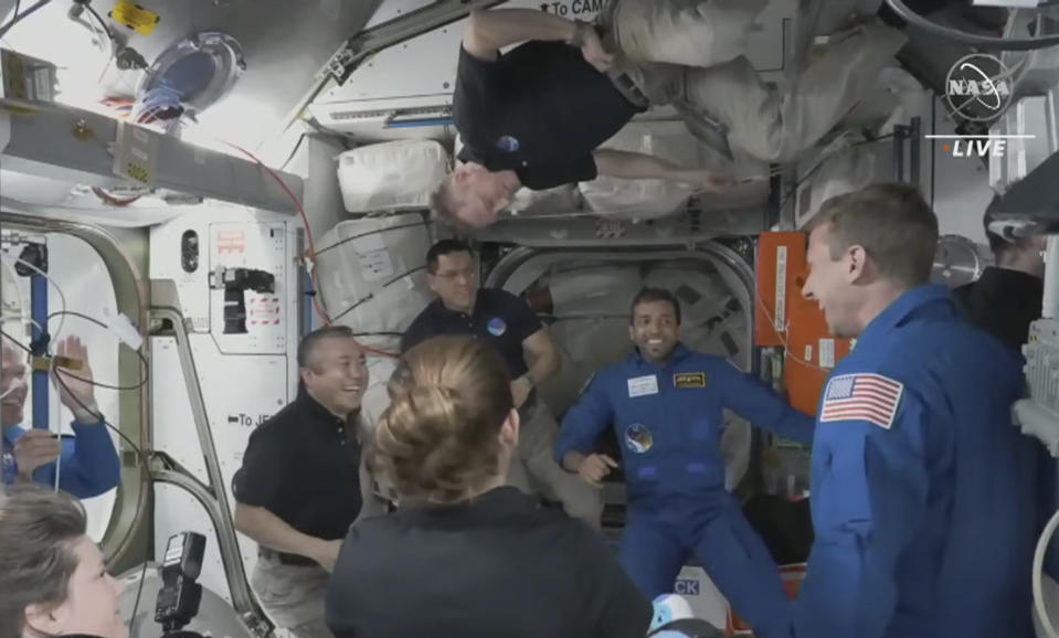 In this image from NASA TV, the four astronauts including United Arab Emirates' Sultan al-Neyadi, centre right, enter the pad of the International Space Station, Friday, March 3, 2023. A new crew from the United States, Russia and United Arab Emirates has arrived at the International Space Station. The new arrivals include United Arab Emirates' Sultan al-Neyadi, the first astronaut from the Arab world who will spend an extended time in space. Al-Neyadi is only the second person from the UAE to rocket into orbit. (NASA TV via AP)