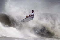 Brazil's Gabriel Medina goes to the air during the quarterfinals of the men's surfing competition at the 2020 Summer Olympics, Tuesday, July 27, 2021, at Tsurigasaki beach in Ichinomiya, Japan. (AP Photo/Francisco Seco)