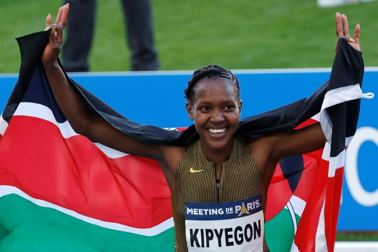 Kenya's Faith Kipyegon reacts after breaking the women's 1500m world record (Geoffroy VAN DER HASSELT)