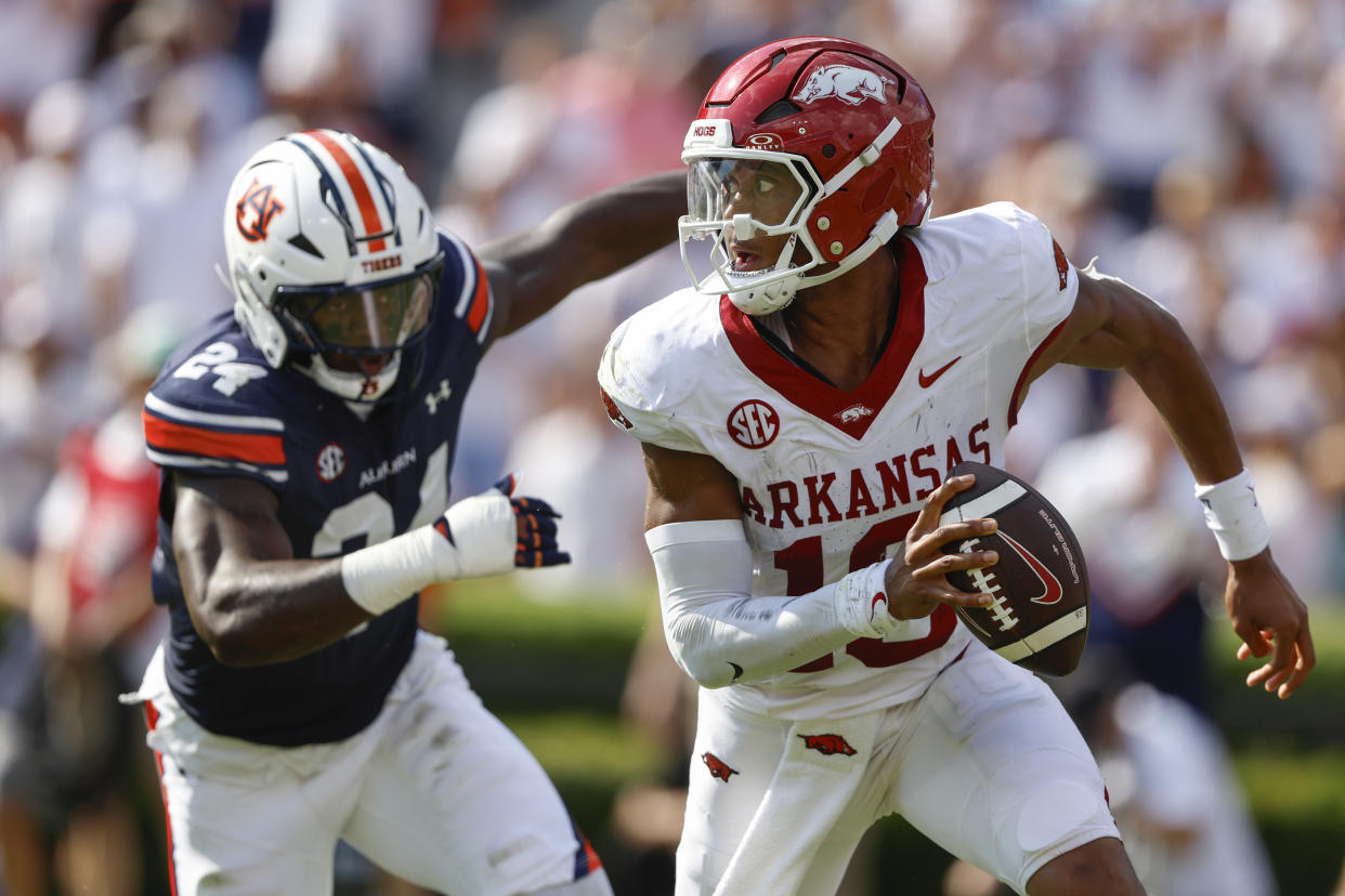 Arkansas quarterback Taylen Green (10) scrambles away from pressure by Auburn nose tackle Keyron Crawford (24) during the first half of an NCAA college football game, Saturday, Sept. 21, 2024, in Auburn, Ala.(AP Photo/Butch Dill)