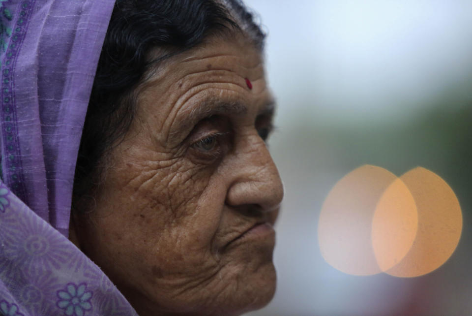 In this Aug. 29, 2019, photo, Kashmiri Hindu woman Arun Ditti, walks inside her residence at the Muthi migrant camp in Jammu, India. Tens of thousands of Kashmiri Hindus fled the restive region nearly 30 years ago, and the ghost of insurgency and their mass exodus still haunts them. They celebrated after India’s Hindu nationalist-led government stripped political autonomy from its part of Muslim-majority Kashmir on Aug. 5. Kashmiri Hindus view it as a step toward justice and possible return to their homeland. But many are still wary of returning. (AP Photo/Channi Anand)