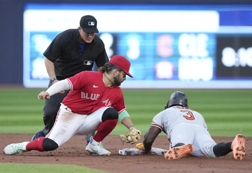 Baltimore Orioles' Jorge Mateo (3) steals second base as Toronto Blue Jays shortstop Bo Bichette, front left, is late on a tag during second-inning baseball game action in Toronto, Monday, July 31, 2023. (Nathan Denette/The Canadian Press via AP)