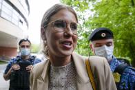 Russian opposition activist Lyubov Sobol, a close ally of Alexei Navalny, looks at photographers as she arrives at the court in Moscow, Russia, Tuesday, Aug. 3, 2021. A Russian court on Tuesday restricted Lyubov Sobol move for a year and a half after she was found guilty of violating the COVID-19 safety rules. (AP Photo/Alexander Zemlianichenko)