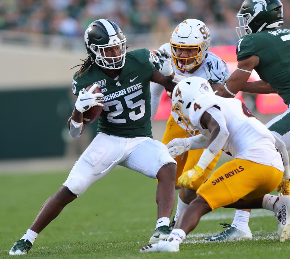 Michigan State Spartans receiver Darrell Stewart Jr. is tackled by Arizona State's Evan Fields (4) and Jermayne Lole (90) during the second half Saturday, Sept. 14, 2019 at Spartan Stadium.