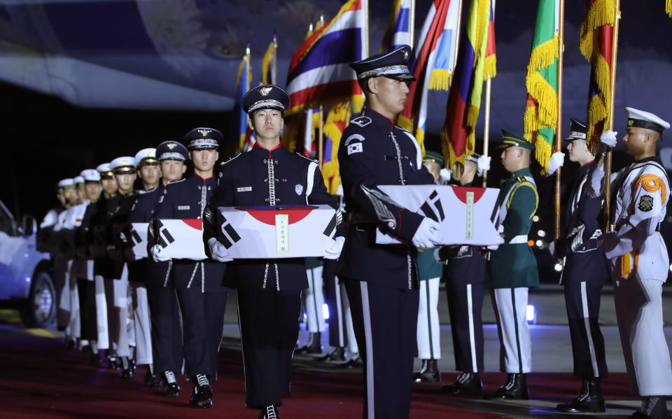 South Korean honor guard soldiers carry caskets containing the remains of 147 South Korean soldiers killed in the 1950-53 Korean War during a ceremony to mark the 70th anniversary of the Korean War at the Seoul airport in Seongnam, South Korea, Thursday, June 25, 2020. (Kim Ju-sung/Yonhap via AP)