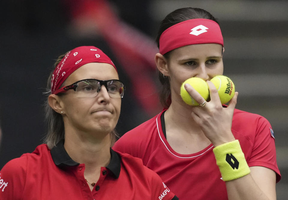 Belgium's Kirsten Flipkens, left, and Greet Minnen talk while playing Canada's Gabriela Dabrowski and Leylah Fernandez in a doubles match during a Billie Jean King Cup tennis qualifier Saturday, April 15, 2023, in Vancouver, British Columbia. (Darryl Dyck/The Canadian Press via AP)