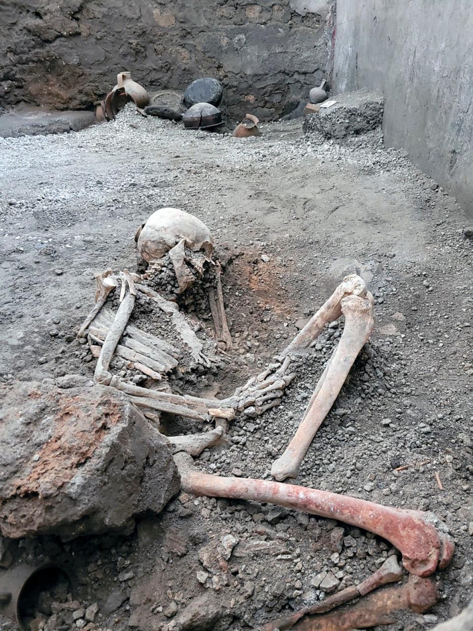 A picture made available Tuesday, May 16, 2023 by the Pompeii Archeological Park press office, showing one of the two discovered skeletons that archeologists believe were men who died when a wall collapsed on them during the powerful earthquakes that accompanied the eruption of Mount Vesuvius that destroyed the ancient city of Pompeii in 79 A.D.